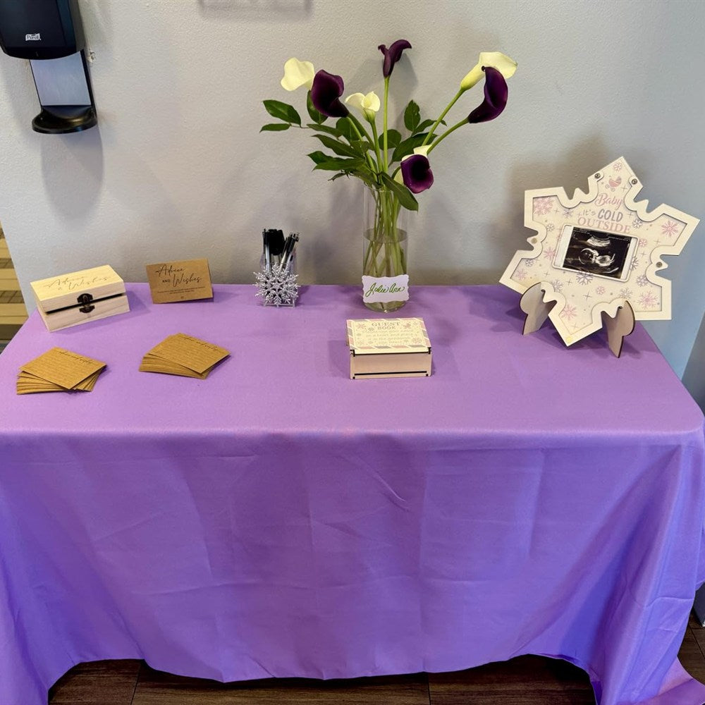 Wooden advice and wishes box on a baby shower guest table