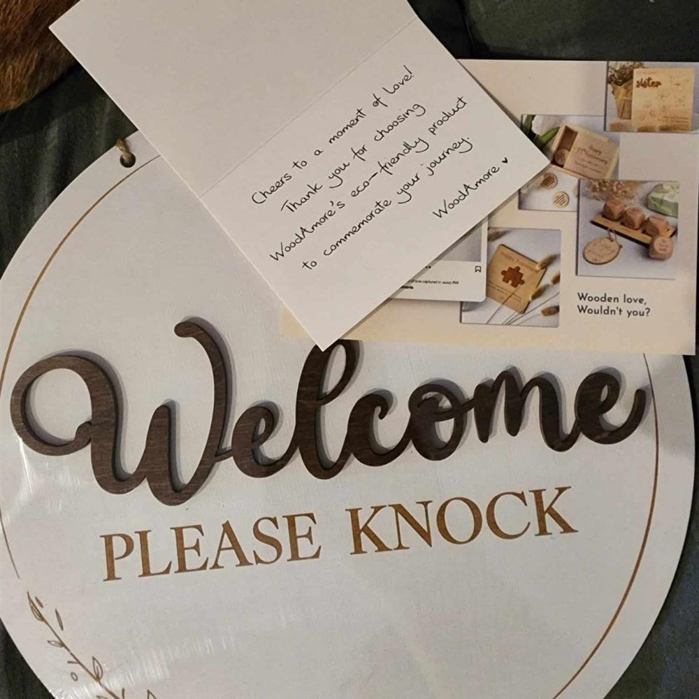 Welcome — Please Knock round wood door sign with a Woodamore thank-you card